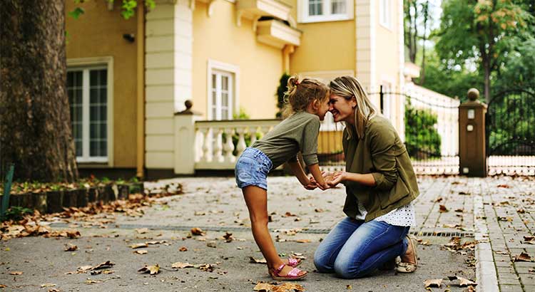 woman kneeling next to child